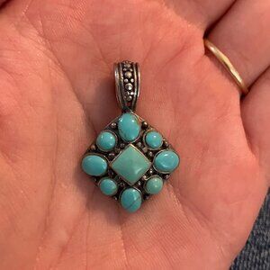 worked, Native American-made sterling silver and turquoise pendant